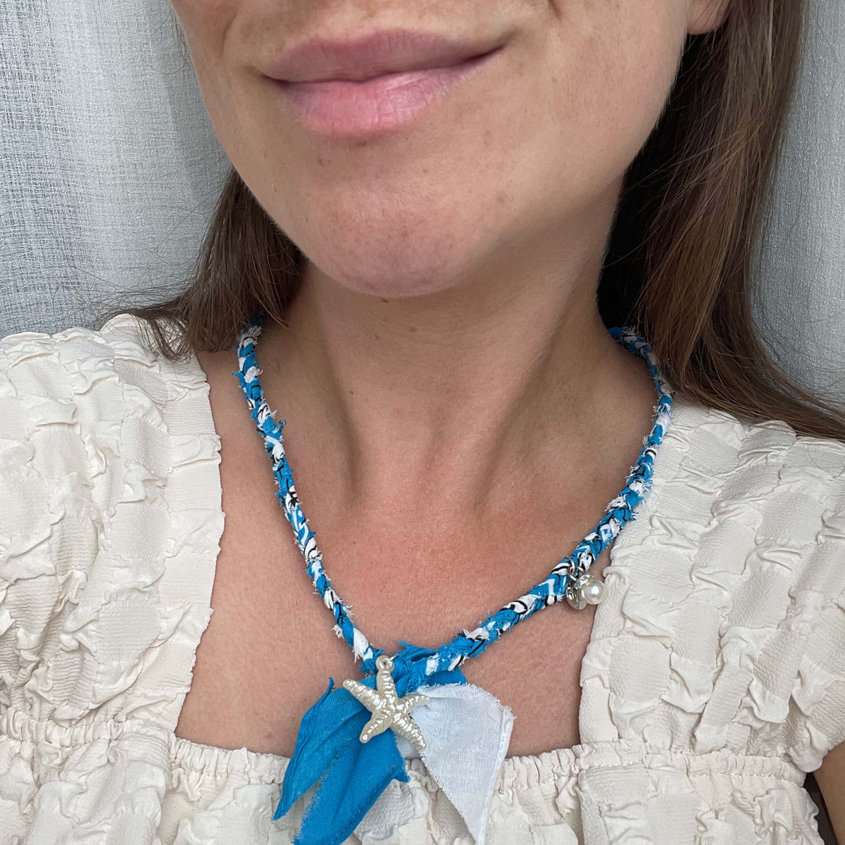 Gevlochten bandana ketting met grote zeester bedel en parel